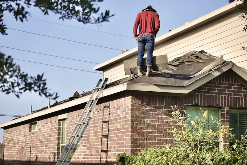 Professional roofer working on a residential roof in Monmouth Heights at Marlboro